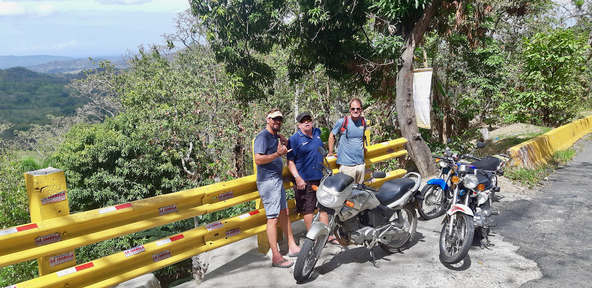 people posing by motorcycle