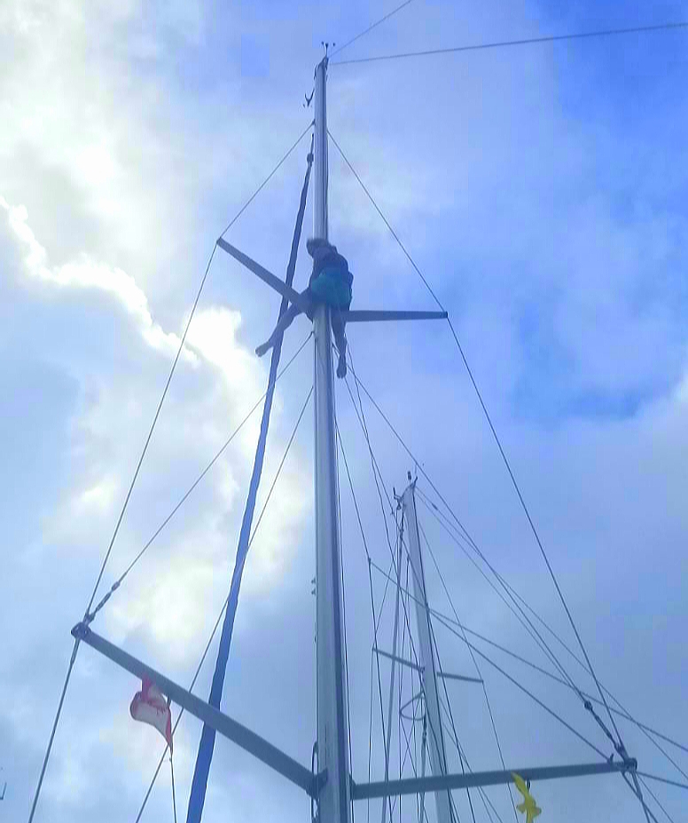 Up the mast keeping busy in quarantine on a sailboat in Bonaire