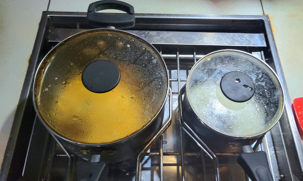 Pots on a marine stove with holders one of the lessons from our long passage