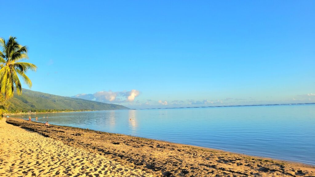 Beach in Tahiti. Sand and calm sea.