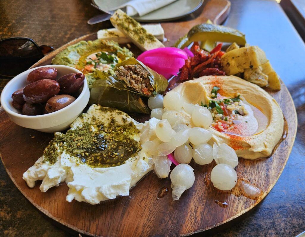 assorted dips, pickles, olives on a plate